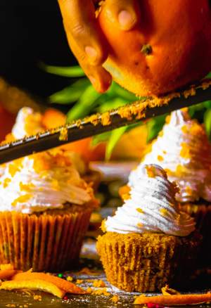 adding orange zest on the cupcakes