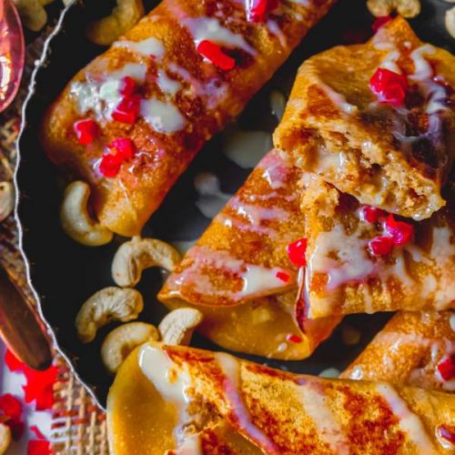 Gurer Patishapta with Coconut Filling on a plate