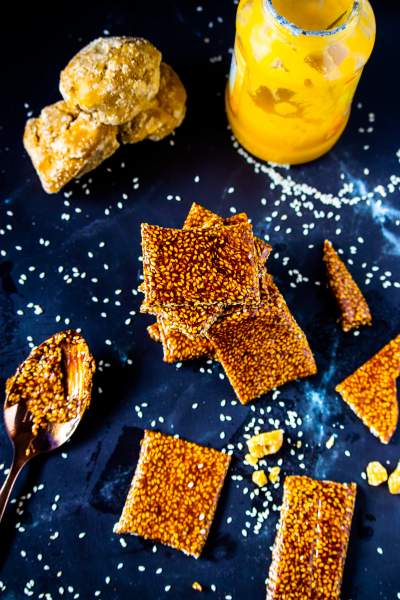 til gud chikki kept on a black table with gud and ghee